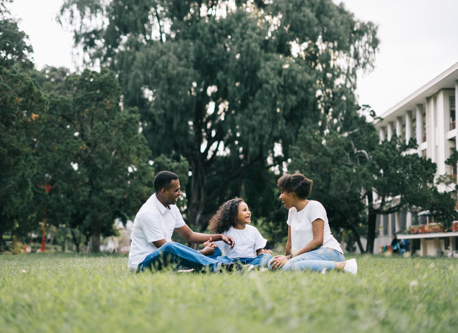 A family talking together outdoors in a park