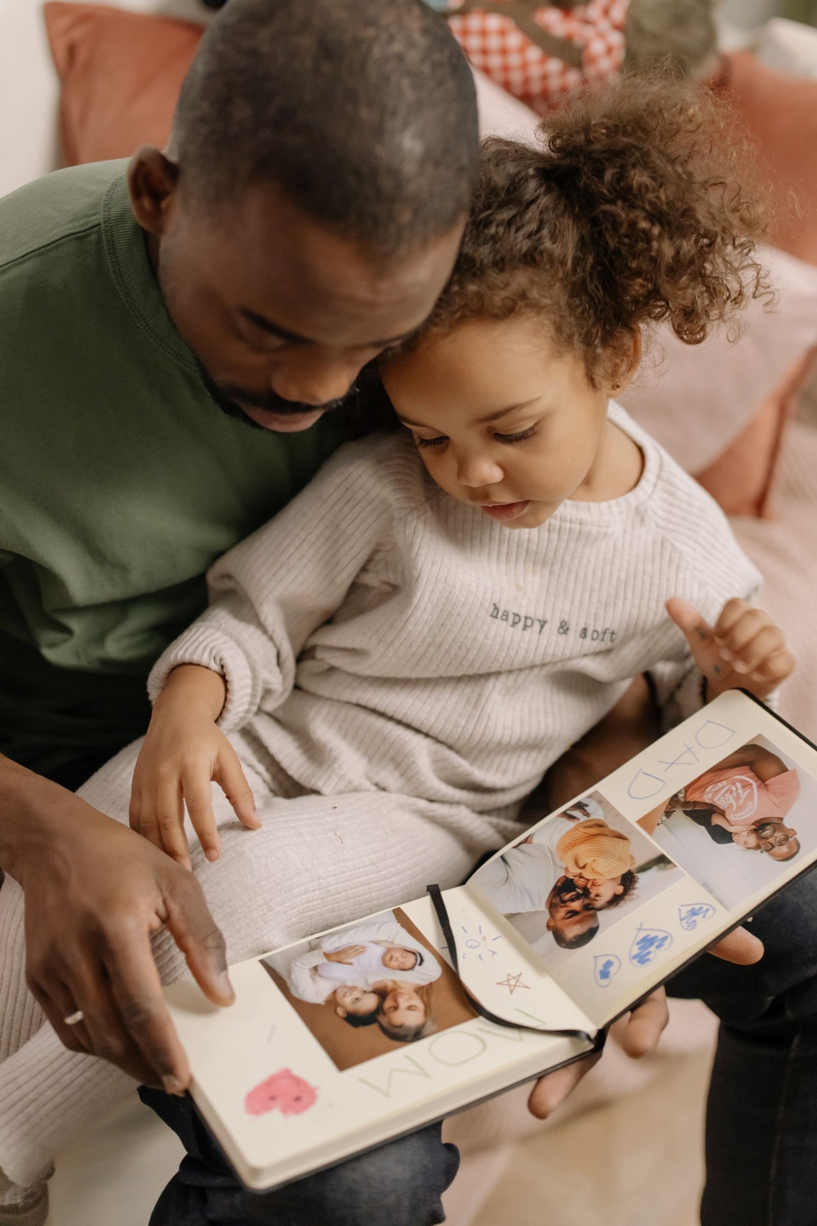 A father and daughter sharing family memories from a photo album